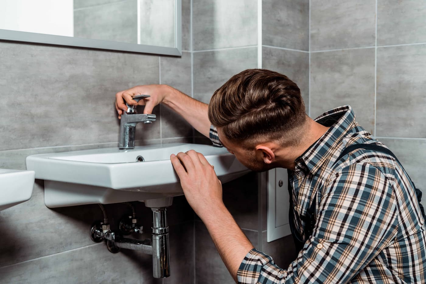 Plumber checking water faucet