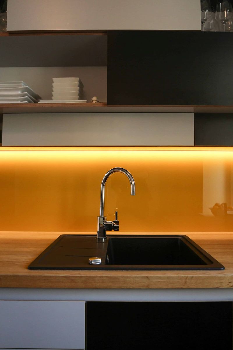 Kitchen sink with bright orange kitchen splash 